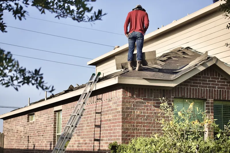 Professional roofer working on a residential roof in Weatherford